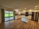Modern kitchen with stainless steel appliances, white cabinets, an island, and wood-look flooring at 5629 Boulder Blvd, Sarasota, FL 34233