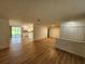 Open-concept living area with stylish wood flooring extending into the adjacent kitchen at 5629 Boulder Blvd, Sarasota, FL 34233