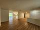 Open-concept living area with stylish wood flooring extending into the adjacent kitchen at 5629 Boulder Blvd, Sarasota, FL 34233