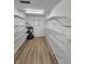 Spacious pantry with ample shelving and a durable laminate wood floor at 5629 Boulder Blvd, Sarasota, FL 34233