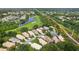 Beautiful aerial view of homes in a lush, green community with a golf course and pond nearby at 6155 Aviary Ct, Bradenton, FL 34203