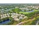 Picturesque aerial view featuring a community with water views, golf course, and well-manicured landscaping at 6155 Aviary Ct, Bradenton, FL 34203