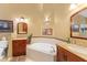 Beautiful primary bathroom with a soaking tub and dual vanities with granite countertops at 6155 Aviary Ct, Bradenton, FL 34203