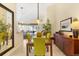 Well-lit dining room with an elegant table, seamlessly connected to the living area and screened-in patio at 6155 Aviary Ct, Bradenton, FL 34203