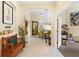 Bright entryway with tile floors, decorative bench, and seamless flow into the dining and living spaces at 6155 Aviary Ct, Bradenton, FL 34203