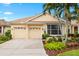 Charming one-story home features a well-maintained front yard with mature landscaping, a tile roof, and a two-car garage at 6155 Aviary Ct, Bradenton, FL 34203