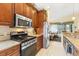 Well-equipped kitchen featuring stainless steel appliances and light granite countertops at 6155 Aviary Ct, Bradenton, FL 34203