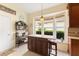 Charming kitchen island area with a breakfast bar and a view of the lush, green landscaping through the window at 6155 Aviary Ct, Bradenton, FL 34203