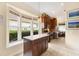 Well-lit kitchen island offering seating and scenic views, seamlessly connecting to the adjacent kitchen and living areas at 6155 Aviary Ct, Bradenton, FL 34203