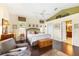 Spacious primary bedroom with wood floors, ample natural light, and ensuite bathroom at 6155 Aviary Ct, Bradenton, FL 34203