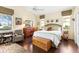Bright and inviting primary bedroom featuring hardwood floors and multiple windows at 6155 Aviary Ct, Bradenton, FL 34203