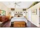 Relaxing primary bedroom with wood floors, large windows, and en-suite bathroom at 6155 Aviary Ct, Bradenton, FL 34203