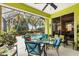 Screened lanai with view of the golf course and pool is ideal for outdoor dining and relaxation at 6155 Aviary Ct, Bradenton, FL 34203