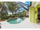 Private screened-in pool with lush landscaping creates a tranquil outdoor oasis at 6155 Aviary Ct, Bradenton, FL 34203