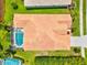 Overhead view showcases the layout with a screened pool, the roof's unique design, and the lush backyard at 6216 Donnington Ct, Sarasota, FL 34238