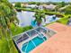 Aerial view of the home with a screened pool and spa with pond view, providing a private and luxurious outdoor space at 6216 Donnington Ct, Sarasota, FL 34238