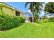 Well-manicured lawn and tropical landscaping surrounds the home with a screened in porch, offering shade and privacy at 6216 Donnington Ct, Sarasota, FL 34238