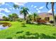 Expansive backyard with a tranquil pond view and a variety of trees that create a serene and inviting outdoor space at 6216 Donnington Ct, Sarasota, FL 34238