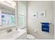 Charming bathroom with a window, fun art and a blue crocodile towel at 6216 Donnington Ct, Sarasota, FL 34238
