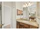Granite countertop vanity with a large mirror reflecting the hallway, plus a linen closet at 6216 Donnington Ct, Sarasota, FL 34238