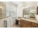 Bright bathroom with a granite countertop vanity, lots of storage, and a glass-enclosed shower at 6216 Donnington Ct, Sarasota, FL 34238
