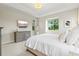 Inviting bedroom featuring a comfortable bed, dresser, and ample natural light from the window at 6216 Donnington Ct, Sarasota, FL 34238
