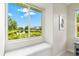 Bedroom showcasing a window seat offering scenic views of the community pond at 6216 Donnington Ct, Sarasota, FL 34238