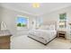 Serene bedroom with a large window, comfortable bed, and natural light at 6216 Donnington Ct, Sarasota, FL 34238