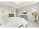 Bedroom featuring a comfortable bed, stylish dressers, and ample natural light at 6216 Donnington Ct, Sarasota, FL 34238
