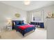 Cozy bedroom featuring neutral walls, a window and a navy blue bed at 6216 Donnington Ct, Sarasota, FL 34238