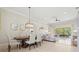 Open concept dining room flowing into the living room with views of the lanai at 6216 Donnington Ct, Sarasota, FL 34238
