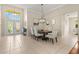 Elegant dining room featuring a chandelier, neutral colors, and a view of the front entrance at 6216 Donnington Ct, Sarasota, FL 34238