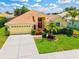 Charming home with a well-maintained lawn, red front door, and lush landscaping that enhances curb appeal at 6216 Donnington Ct, Sarasota, FL 34238
