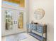 Bright foyer with decorative glass doors, neutral paint, and a stylish console table at 6216 Donnington Ct, Sarasota, FL 34238