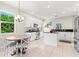 Bright kitchen featuring an island, white cabinets, stainless steel appliances, and a breakfast nook at 6216 Donnington Ct, Sarasota, FL 34238