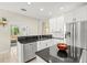Modern kitchen with granite countertops, stainless steel appliances, and white cabinetry at 6216 Donnington Ct, Sarasota, FL 34238