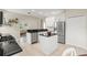 Stylish kitchen with white cabinets, stainless steel appliances, granite countertops, and center island at 6216 Donnington Ct, Sarasota, FL 34238