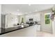 Bright kitchen with stainless steel appliances, white cabinetry and a spacious island with black countertop at 6216 Donnington Ct, Sarasota, FL 34238