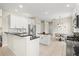 Open kitchen with granite countertops, stainless steel appliances, and adjoining breakfast nook at 6216 Donnington Ct, Sarasota, FL 34238