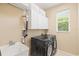 This laundry room has a new front load washer and dryer, sink and storage, with a window for natural light at 6216 Donnington Ct, Sarasota, FL 34238