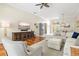 Bright living room with hardwood floors, comfortable seating, and a stylish entertainment center at 6216 Donnington Ct, Sarasota, FL 34238