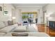 Sun-filled living room with hardwood floors, neutral furniture, and sliding doors to the backyard at 6216 Donnington Ct, Sarasota, FL 34238