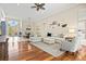 Spacious living room with an open floor plan, hardwood floors, and modern decor at 6216 Donnington Ct, Sarasota, FL 34238