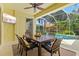 Outdoor patio featuring a dining table and chairs with a ceiling fan and views of the pool at 6216 Donnington Ct, Sarasota, FL 34238