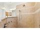 Modern bathroom with tile shower including a rainfall showerhead and handheld wand at 6216 Donnington Ct, Sarasota, FL 34238