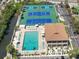 Aerial view of the community tennis and pickle ball courts along with the pool and community center at 6415 Midnight Pass Rd # 502, Sarasota, FL 34242