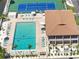 Overhead shot showing the community pool, community center, lounge chairs, and palm trees at 6415 Midnight Pass Rd # 502, Sarasota, FL 34242