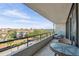 Inviting balcony with lounge chair and bistro set, showcasing neighborhood views at 6415 Midnight Pass Rd # 502, Sarasota, FL 34242