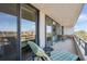 Relaxing balcony view with chaise lounge, table, and chairs, overlooking the cityscape at 6415 Midnight Pass Rd # 502, Sarasota, FL 34242