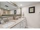 Well-lit bathroom features double sinks, granite countertops, and a large, framed mirror at 6415 Midnight Pass Rd # 502, Sarasota, FL 34242
